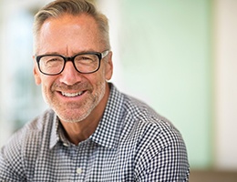 man with glasses smiling