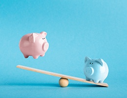 Piggy banks on balance scale