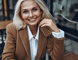 Woman smiling after cosmetic dentistry in Ann Arbor