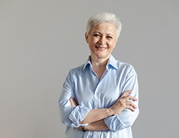 a woman smiling after getting dentures in Ann Arbor