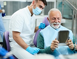 a patient smiling after receiving his dentures in Ann Arbor