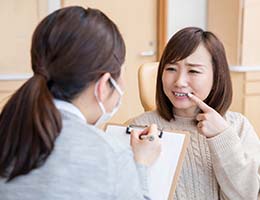 Patient speaking with an Ann Arbor emergency dentist