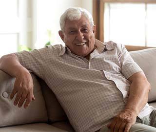 a person lounging on a couch and smiling