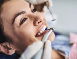 a person getting their teeth polished at the dental office