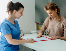 a patient filing out an insurance form