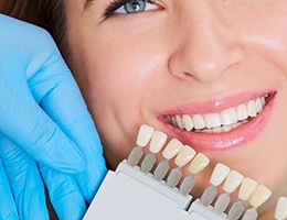 A woman working on a laptop after dental bridge placement