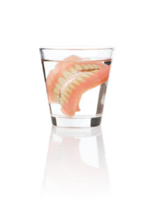Glass with dentures