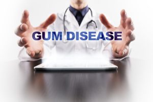 Dentist holding a sign for gum disease in Ann Arbor. 