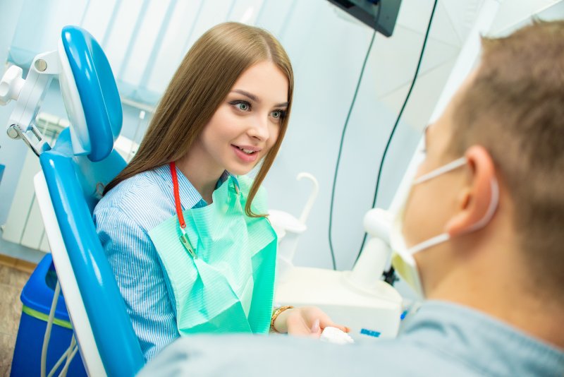 Woman learning the difference between Invisalign and veneers in Ann Arbor