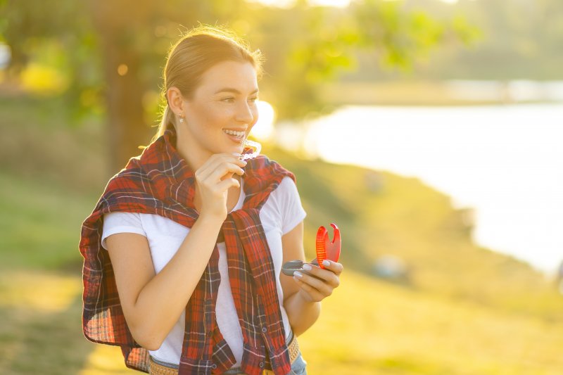 A woman enjoying Invisalign benefits in Ann Arbor