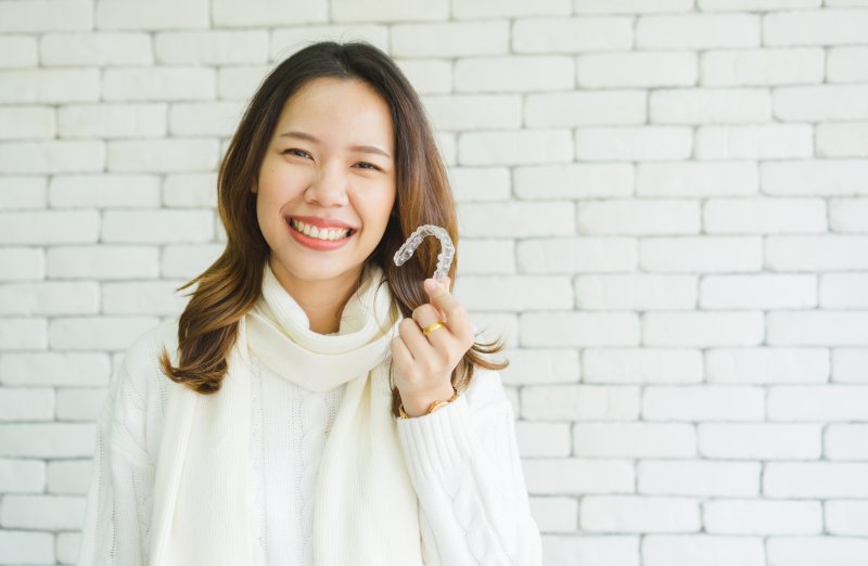 person holding Invisalign